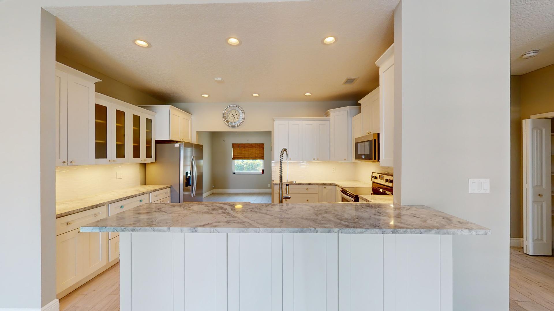 959 N Highway Indialantic, FL 32903 - Photo 10 of 70 a large kitchen with stainless steel appliances granite countertop a large counter top and a stove top oven