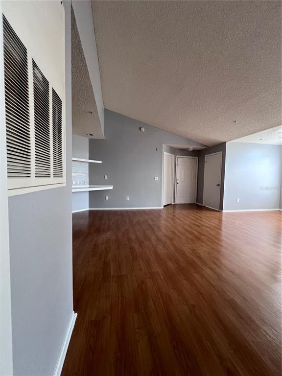 2202 Key W Court, Unit 633 Kissimmee, FL 34741 - Photo 12 of 33 a view of an empty room with wooden floor and a window