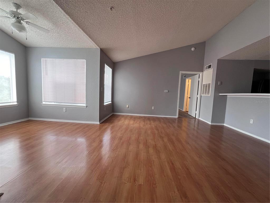 2202 Key W Court, Unit 633 Kissimmee, FL 34741 - Photo 19 of 33 an empty room with wooden floor and windows