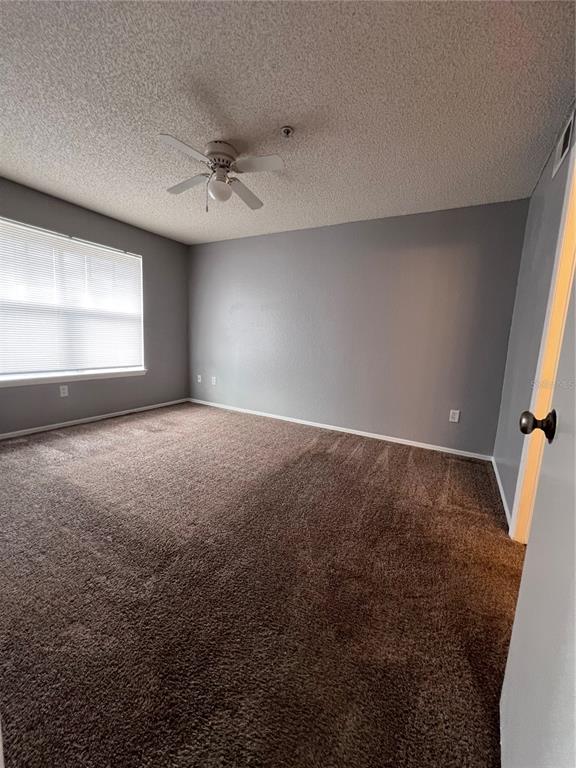 2202 Key W Court, Unit 633 Kissimmee, FL 34741 - Photo 20 of 33 an empty room with windows and fan