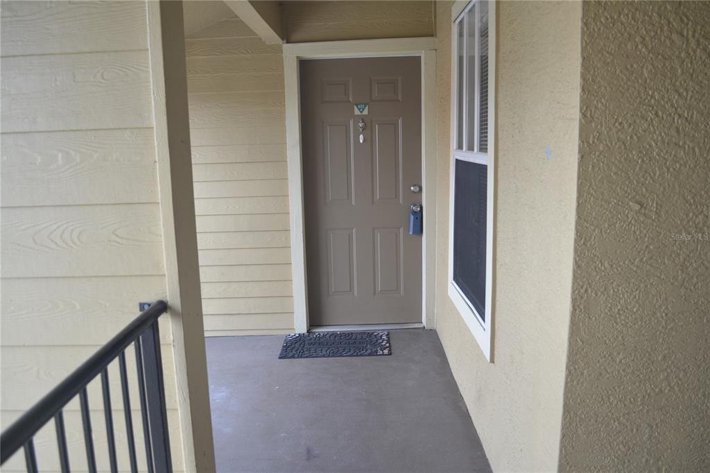 2202 Key W Court, Unit 633 Kissimmee, FL 34741 - Photo 2 of 33 a view of a hallway with a wooden door