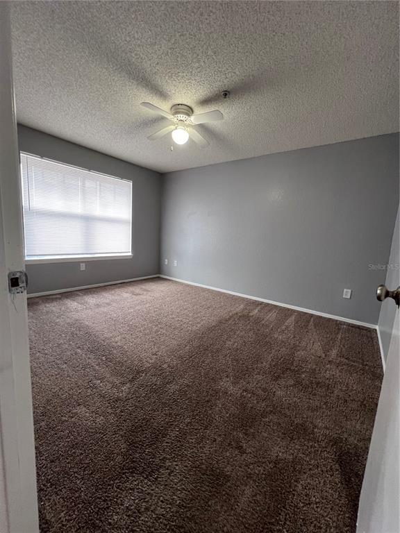 2202 Key W Court, Unit 633 Kissimmee, FL 34741 - Photo 23 of 33 en empty room with windows and fan