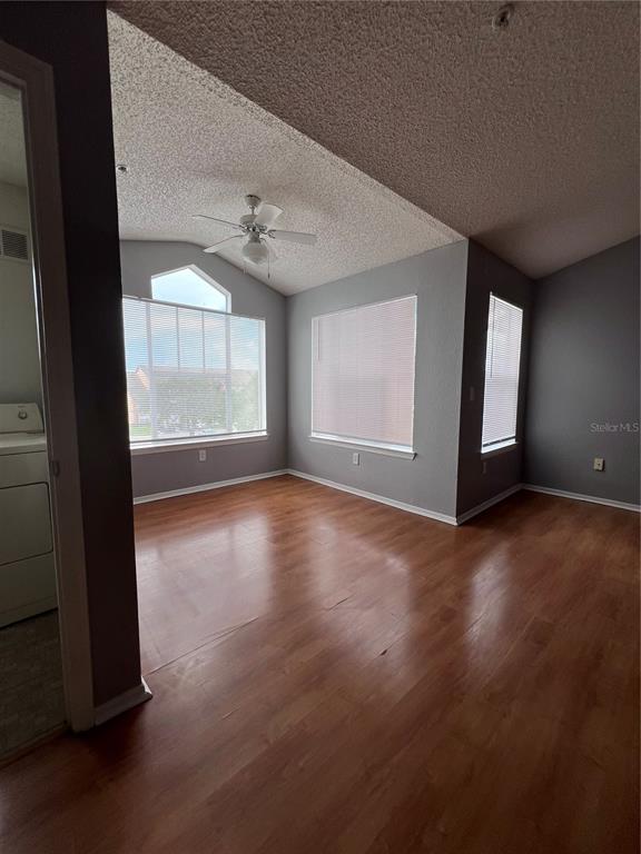 2202 Key W Court, Unit 633 Kissimmee, FL 34741 - Photo 3 of 33 an empty room with wooden floor and windows