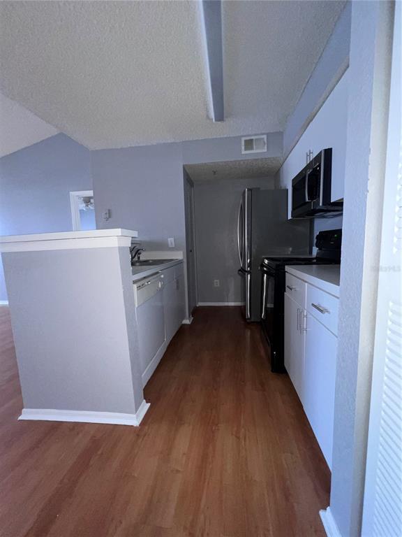 2202 Key W Court, Unit 633 Kissimmee, FL 34741 - Photo 8 of 33 a kitchen with granite countertop a refrigerator stove top oven and sink