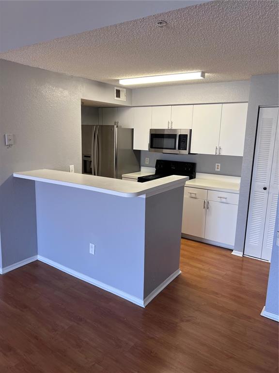 2202 Key W Court, Unit 633 Kissimmee, FL 34741 - Photo 9 of 33 a kitchen with sink cabinets and wooden floor