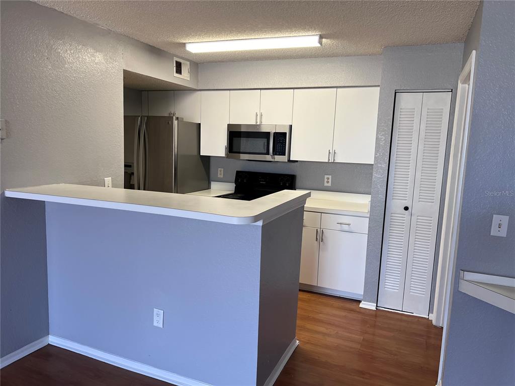 2202 Key W Court, Unit 633 Kissimmee, FL 34741 - Photo 10 of 33 a kitchen with stainless steel appliances a refrigerator and a stove top oven