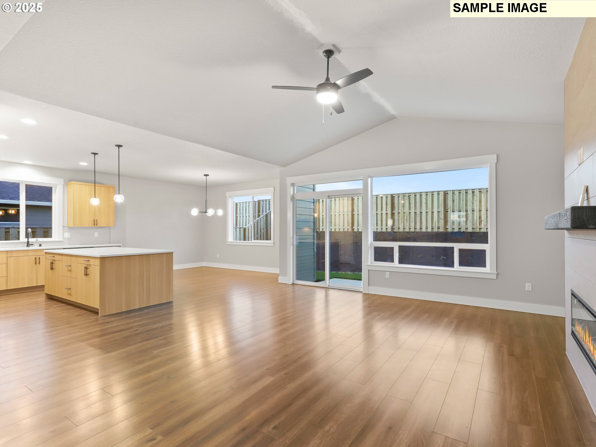 2240 East Otter Loop, Unit 52 La Center, WA 98629 - Photo 11 of 43 a view of an empty room with wooden floor and a kitchen