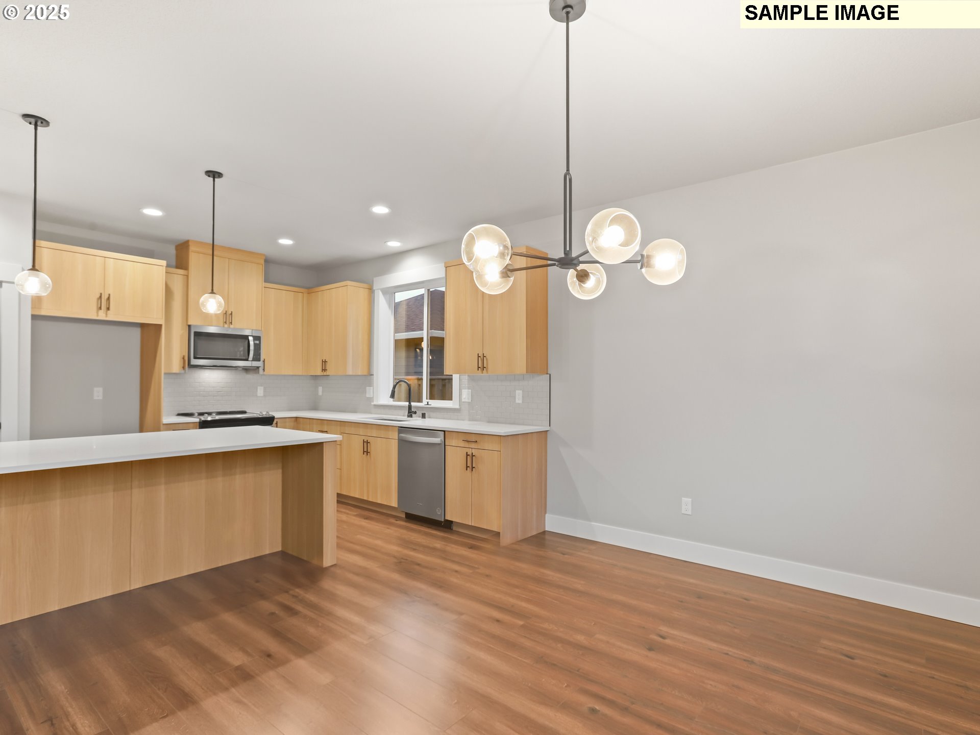 2240 East Otter Loop, Unit 52 La Center, WA 98629 - Photo 13 of 43 a large kitchen with a lot of cabinets and wooden floor