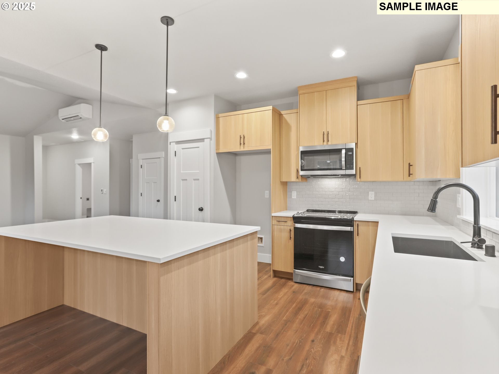 2240 East Otter Loop, Unit 52 La Center, WA 98629 - Photo 15 of 43 a open kitchen with stainless steel appliances granite countertop a sink a stove a refrigerator and island with wooden floor