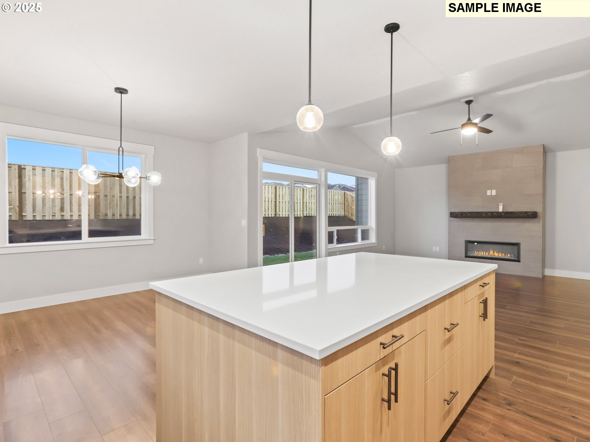 2240 East Otter Loop, Unit 52 La Center, WA 98629 - Photo 16 of 43 a kitchen with kitchen island white cabinets and wooden floor
