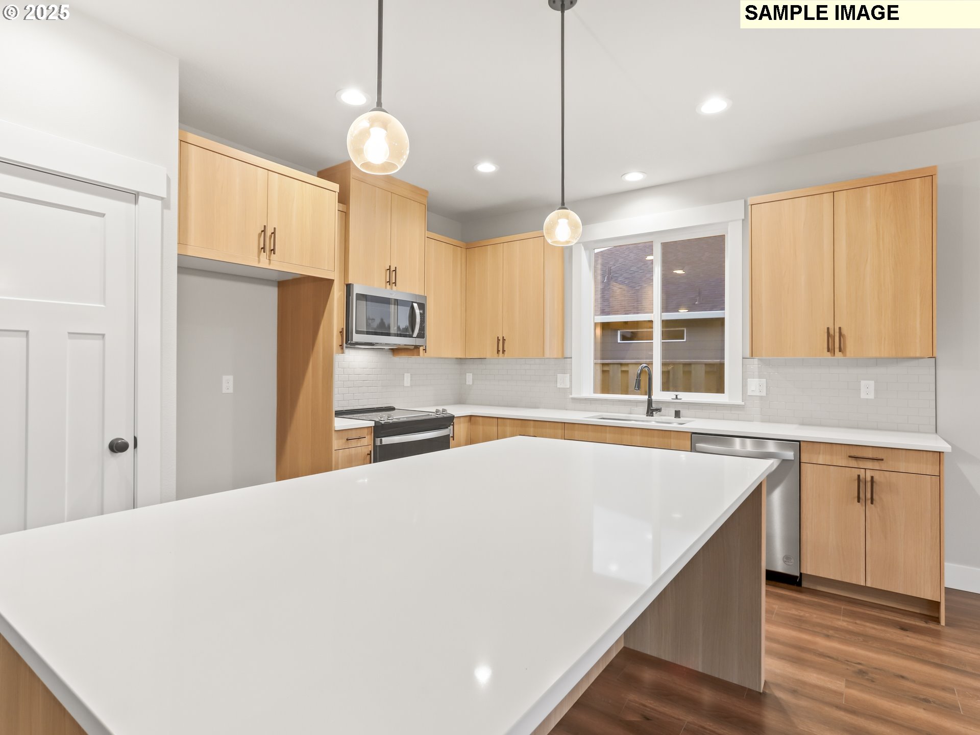 2240 East Otter Loop, Unit 52 La Center, WA 98629 - Photo 18 of 43 a large kitchen with kitchen island a large counter top space appliances and cabinets