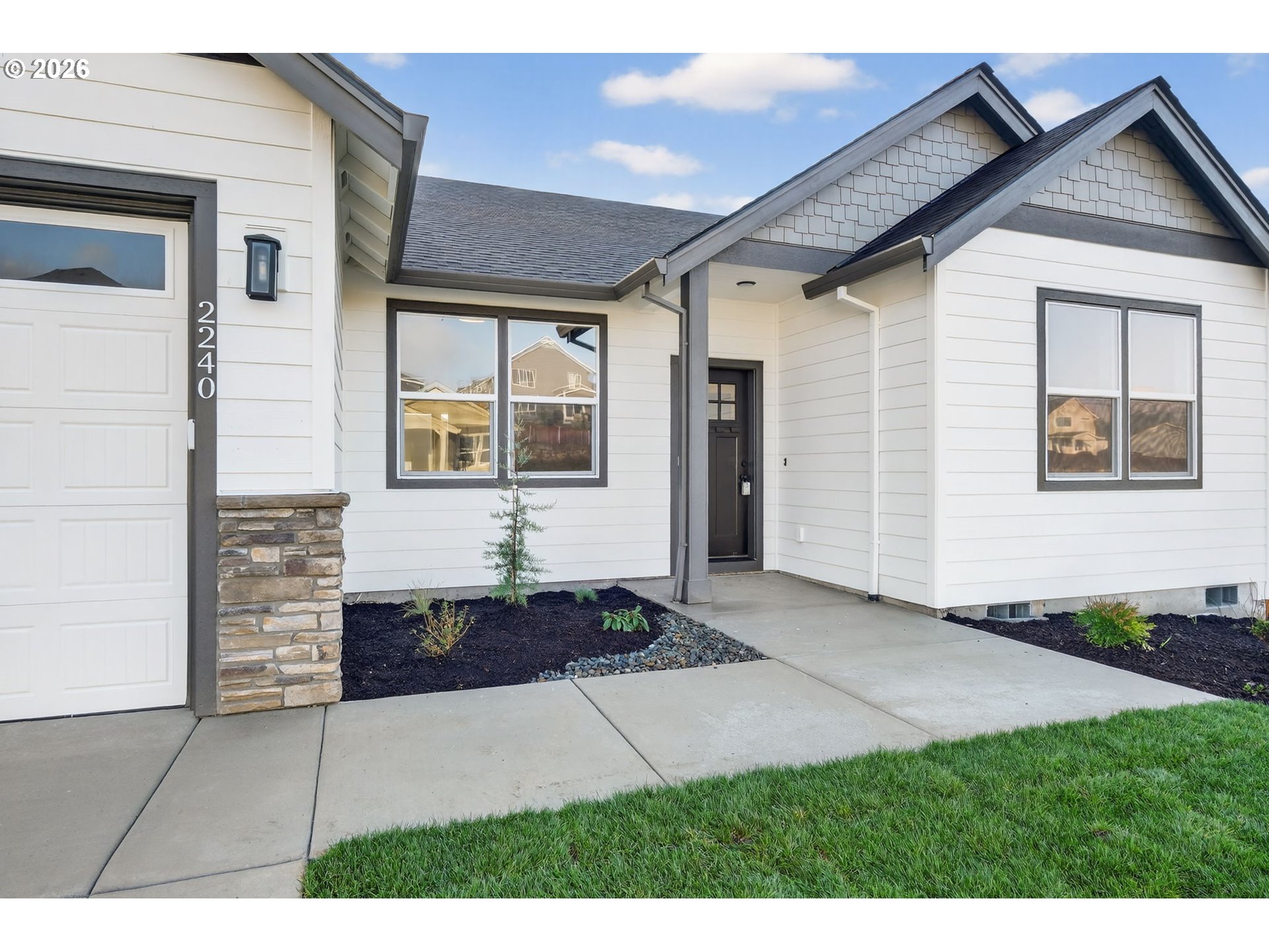2240 East Otter Loop, Unit 52 La Center, WA 98629 - Photo 39 of 43 a front view of a house with a garden