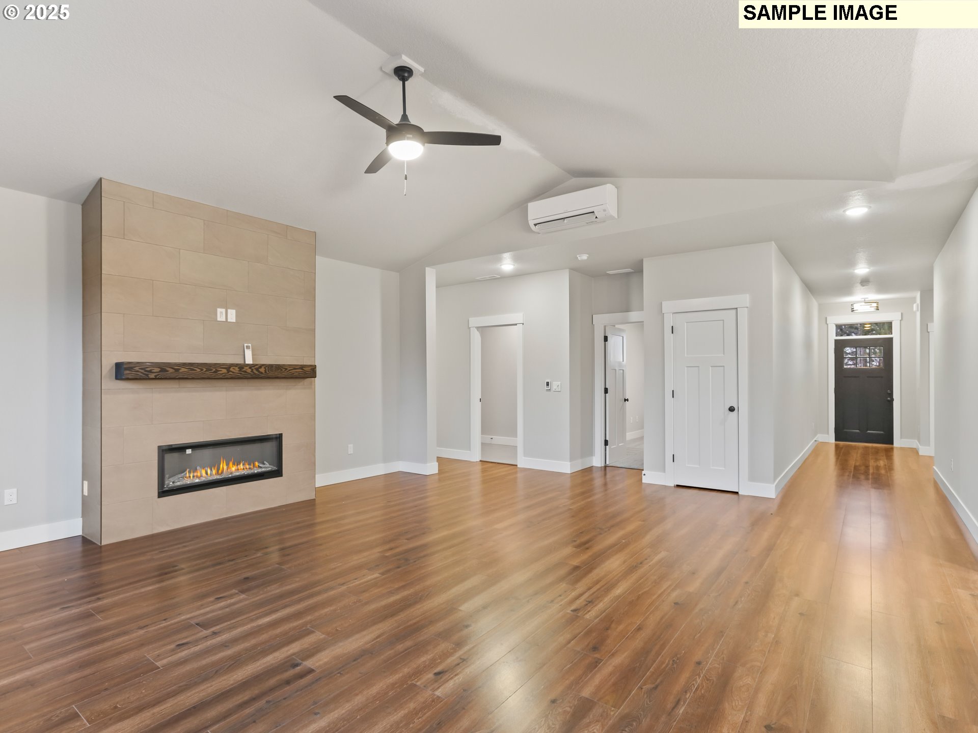 2240 East Otter Loop, Unit 52 La Center, WA 98629 - Photo 9 of 43 a view of an empty room with wooden floor a fireplace and a window