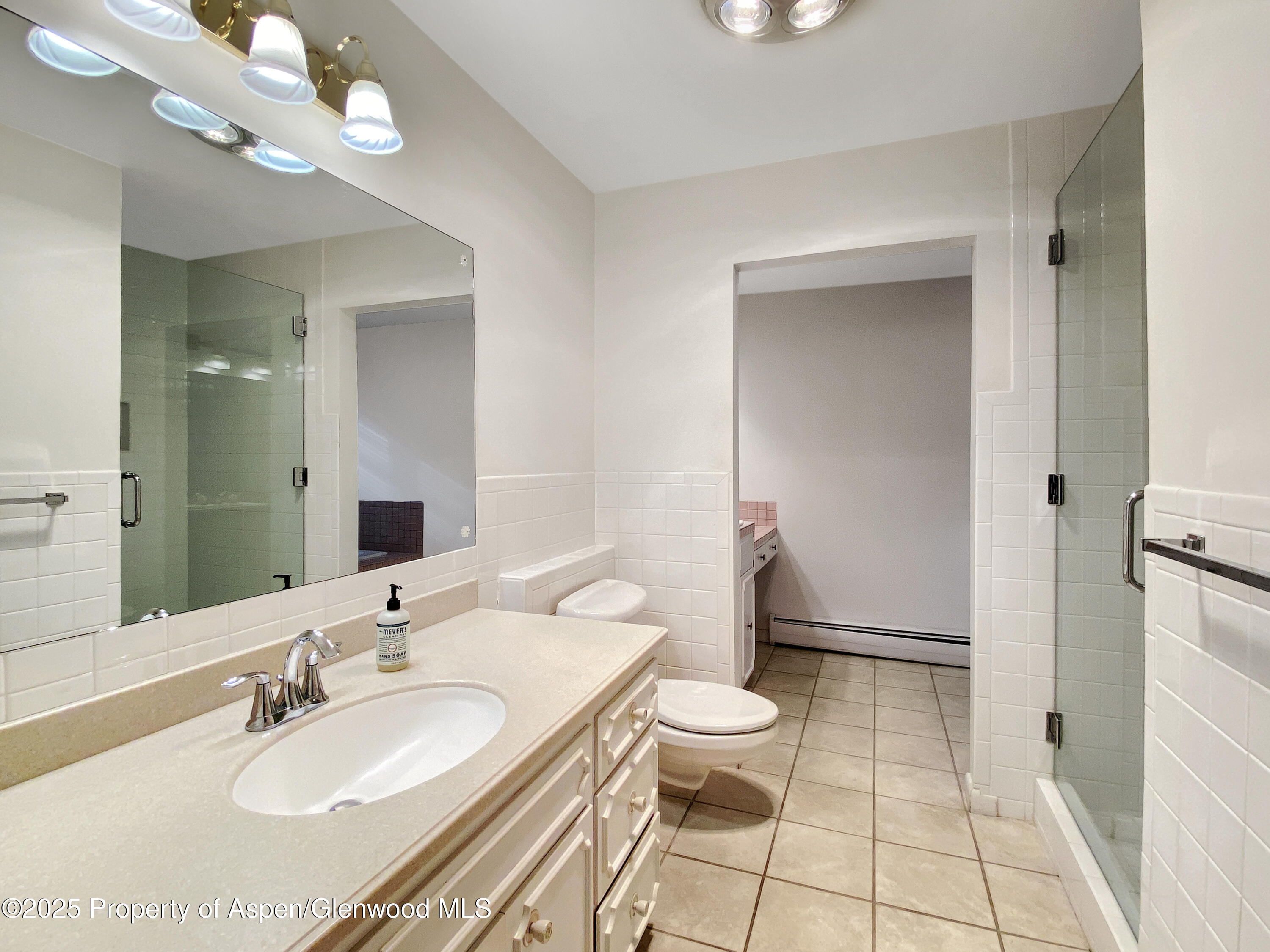 1509 County Road 4 Meeker, CO 81641 - Photo 18 of 37 a spacious bathroom with a granite countertop sink a toilet and a mirror