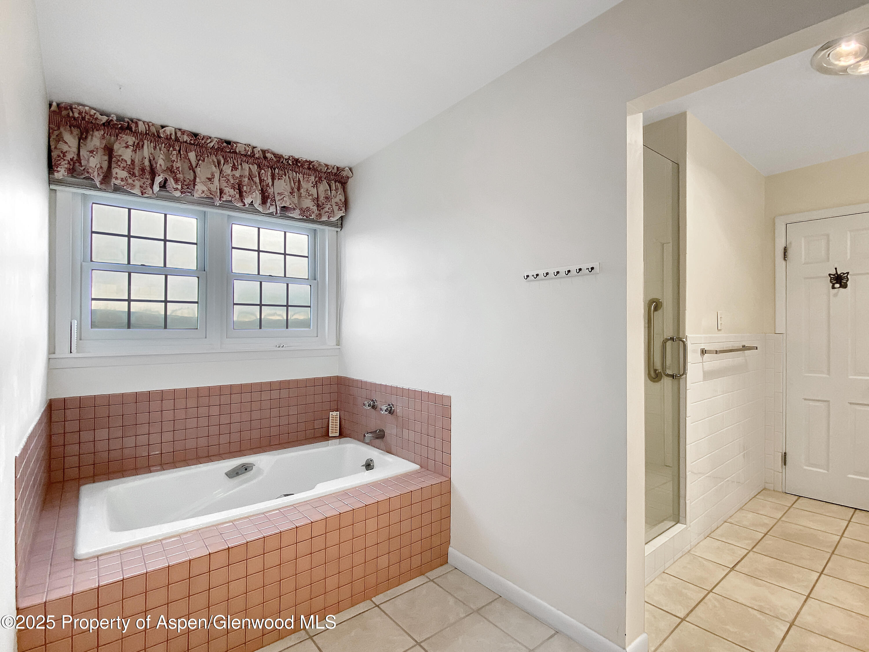 1509 County Road 4 Meeker, CO 81641 - Photo 20 of 37 a bathroom with a bathtub and window
