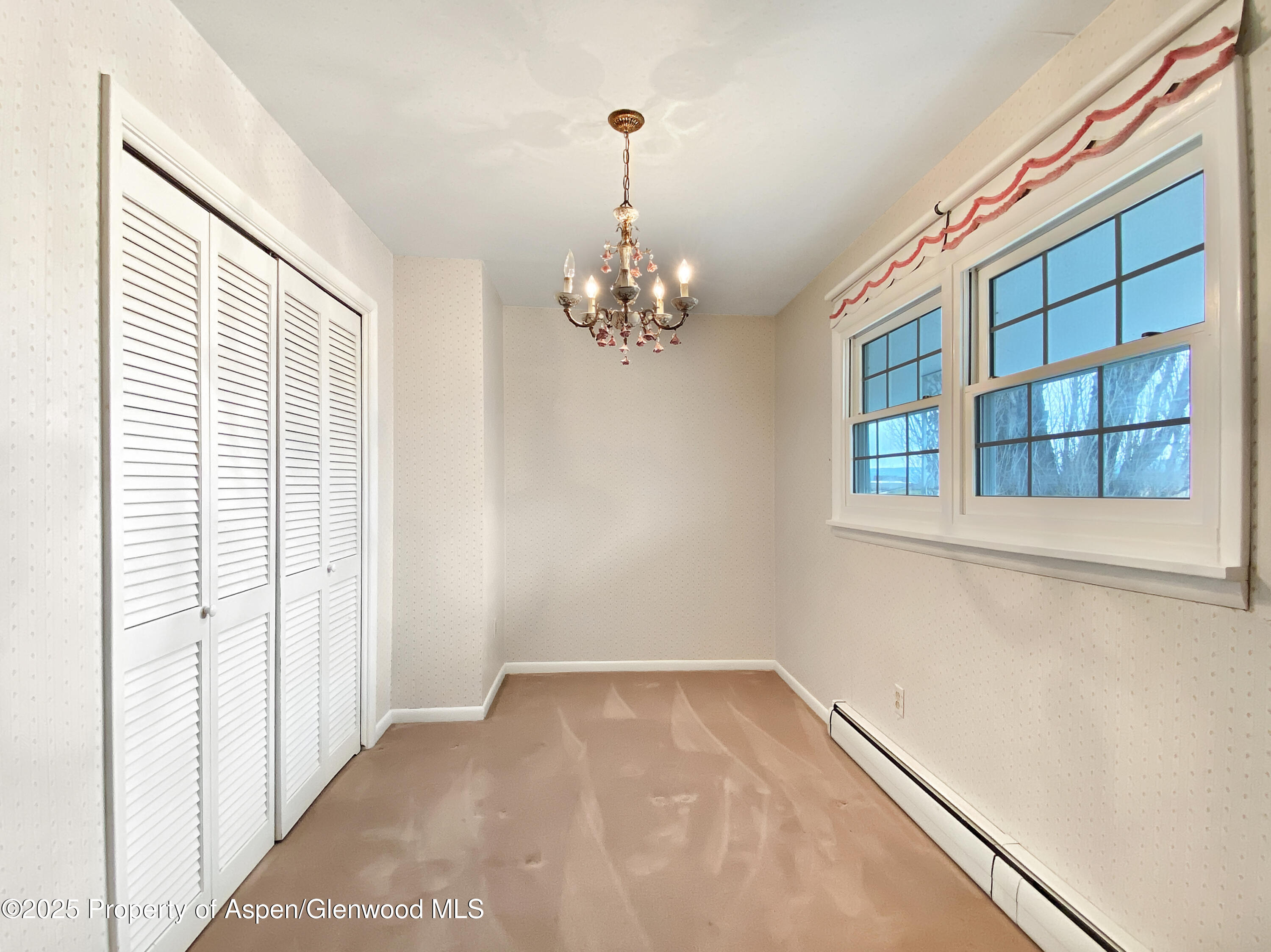 1509 County Road 4 Meeker, CO 81641 - Photo 21 of 37 a view of a hallway with windows and chandelier