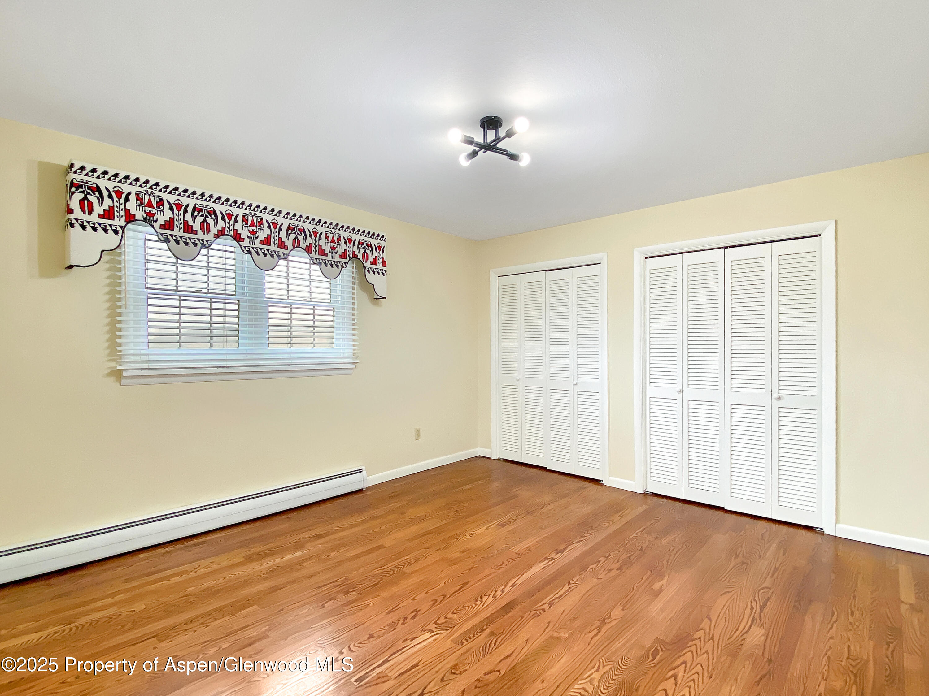 1509 County Road 4 Meeker, CO 81641 - Photo 24 of 37 a view of an empty room with wooden floor and a window