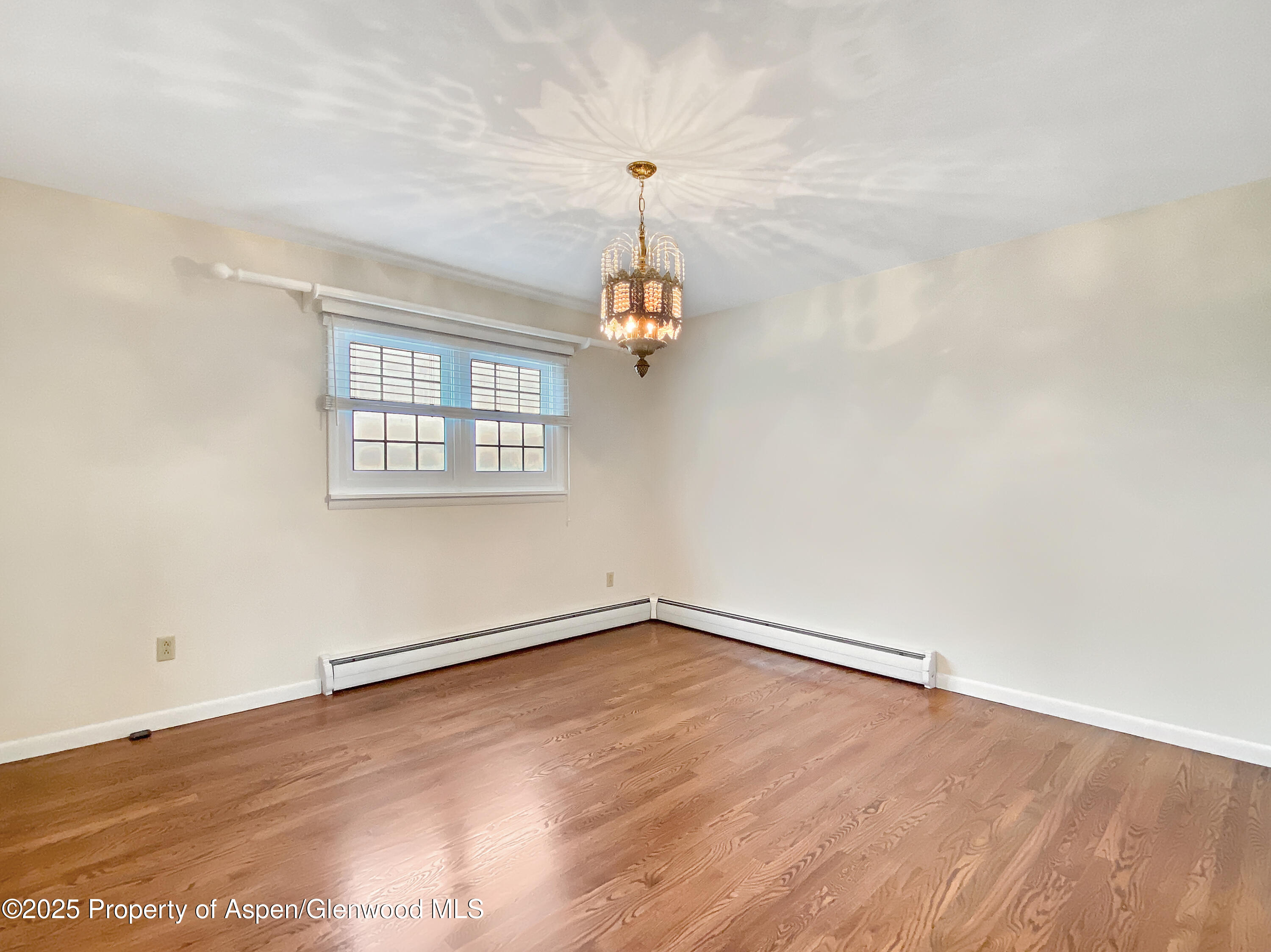 1509 County Road 4 Meeker, CO 81641 - Photo 25 of 37 wooden floor in an empty room with a window