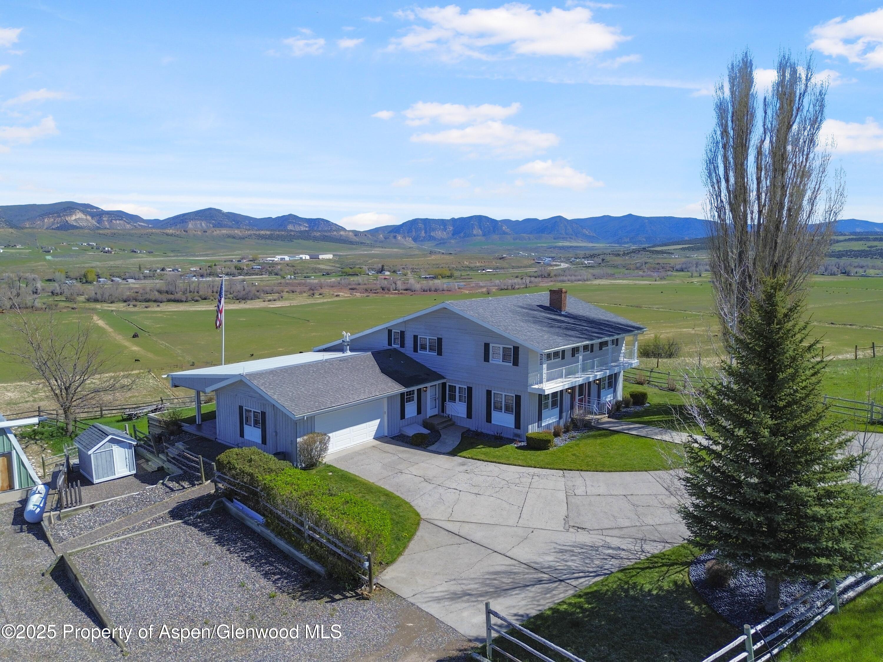 1509 County Road 4 Meeker, CO 81641 - Photo 30 of 37 an aerial view of a house with outdoor space pool lake view and mountain view