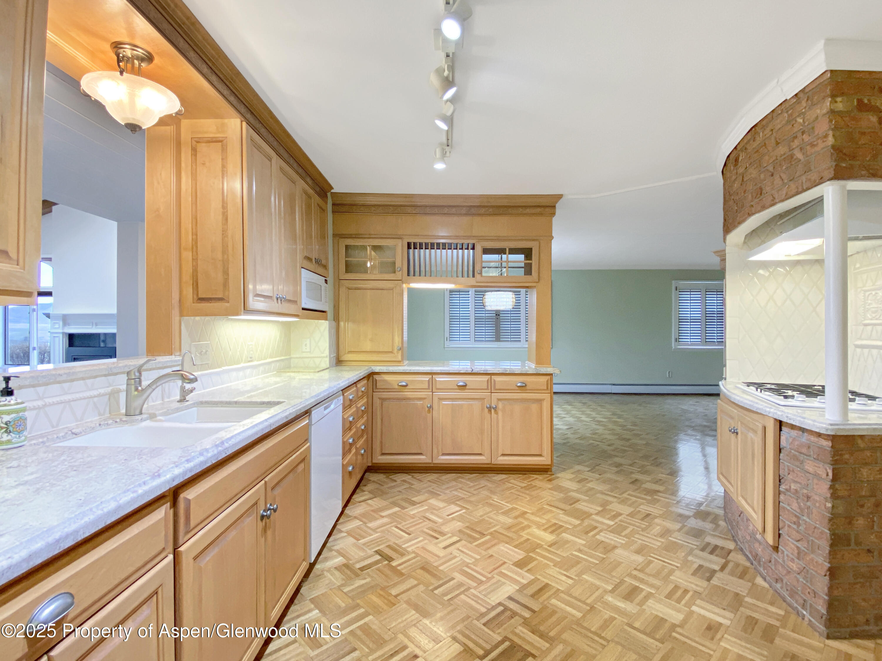 1509 County Road 4 Meeker, CO 81641 - Photo 6 of 37 a large kitchen with kitchen island granite countertop a sink and a stove