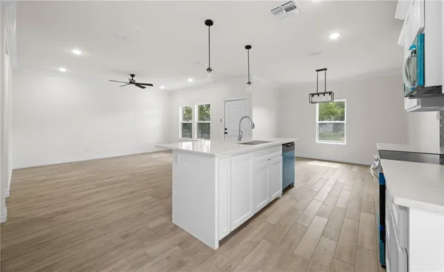 a view of kitchen with sink and wooden floor