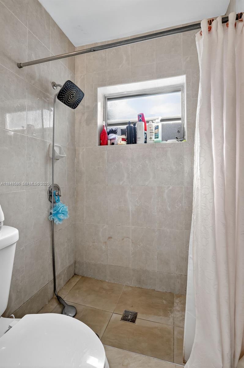 3581 West 2nd Avenue Hialeah, FL 33012 - Photo 14 of 32 a bathroom with a shower a toilet and a sink
