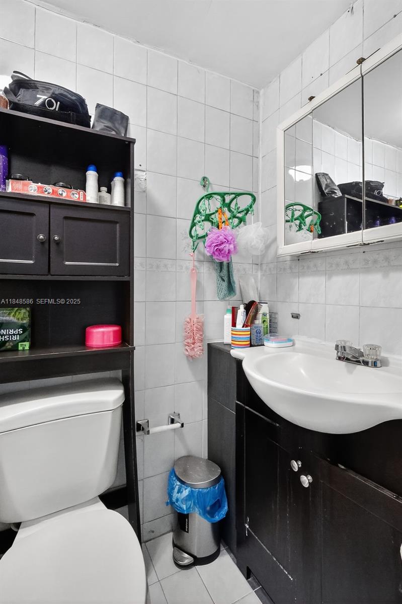 3581 West 2nd Avenue Hialeah, FL 33012 - Photo 20 of 32 a bathroom with a sink a toilet and a shower