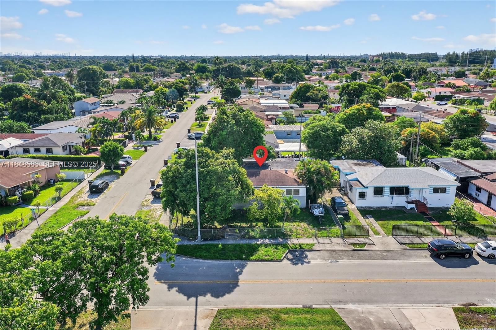 3581 West 2nd Avenue Hialeah, FL 33012 - Photo 24 of 32 an aerial view of a houses with a yard and lake