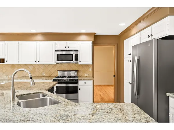 a living room with furniture flat screen tv and a large window