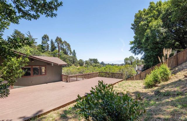 a view of a house with a yard and potted plants