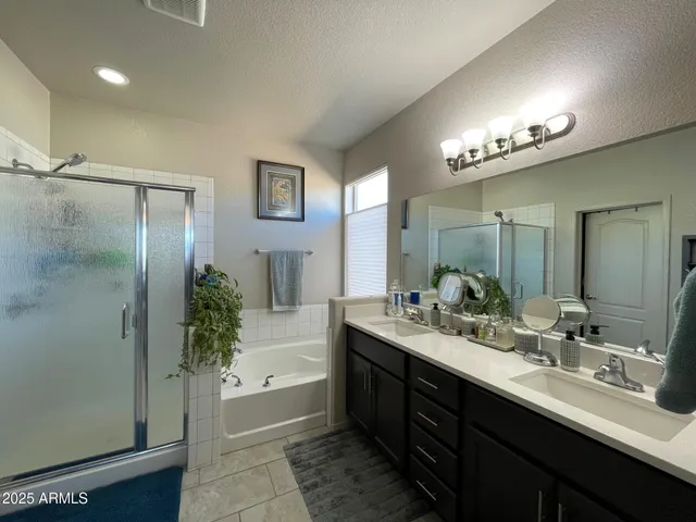 a spacious bedroom with a bed and a chandelier
