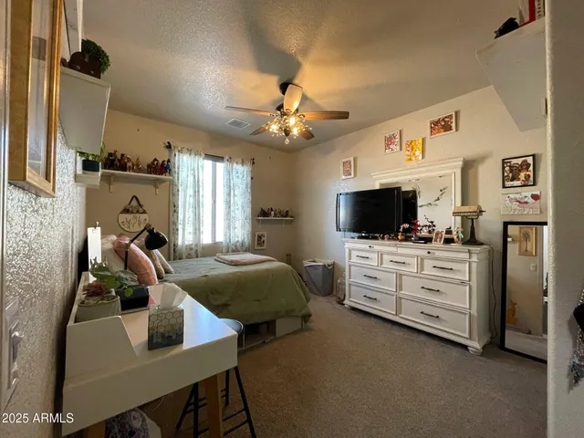 a bedroom with bed and a couch