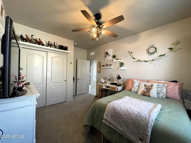 a bedroom with a bed and wooden furniture