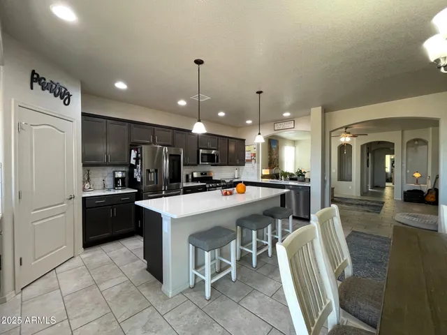 a spacious bedroom with a bed and a flat screen tv