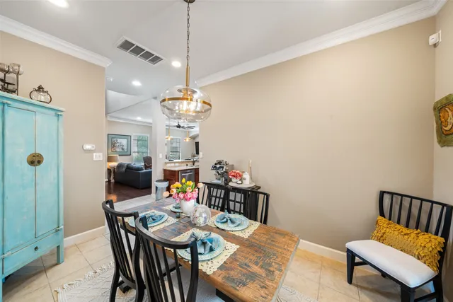 a view of a dining room with furniture and a chandelier