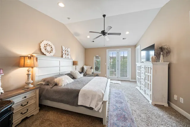 a bedroom with a large bed and a window