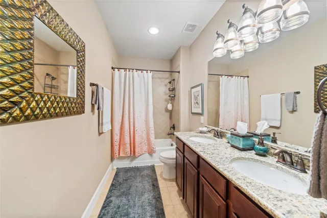 a bathroom with a granite countertop sink a large mirror and a shower