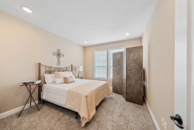 a bedroom with a bed and a mirror