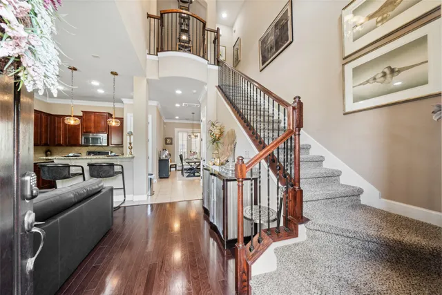 a view of entryway and hall with wooden floor