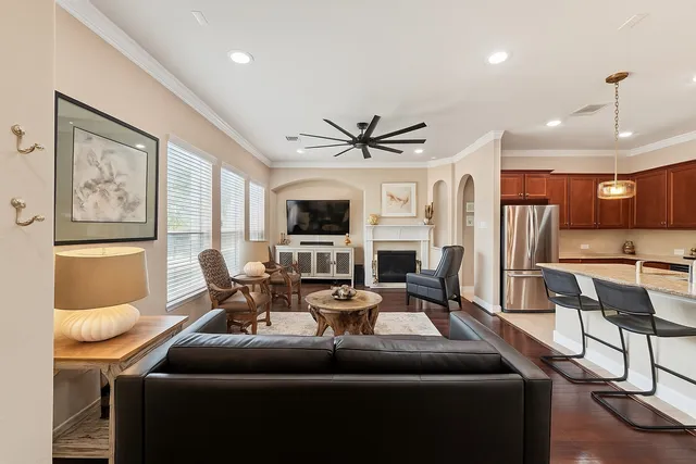 a living room with furniture a fireplace and a flat screen tv