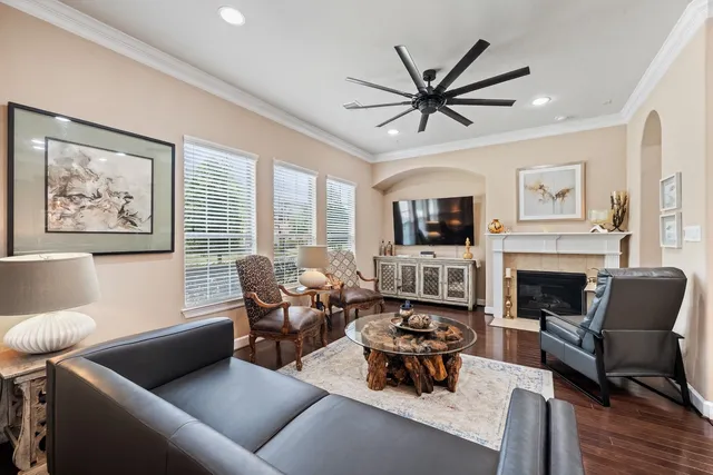 a living room with furniture a fireplace and a floor to ceiling window