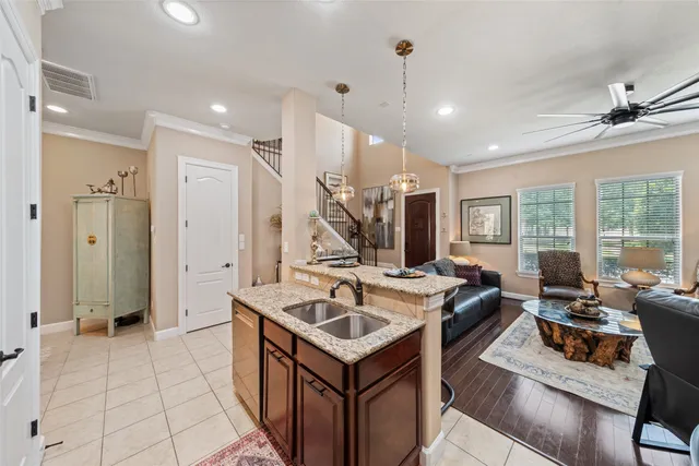 a view of living room filled with furniture and large windows