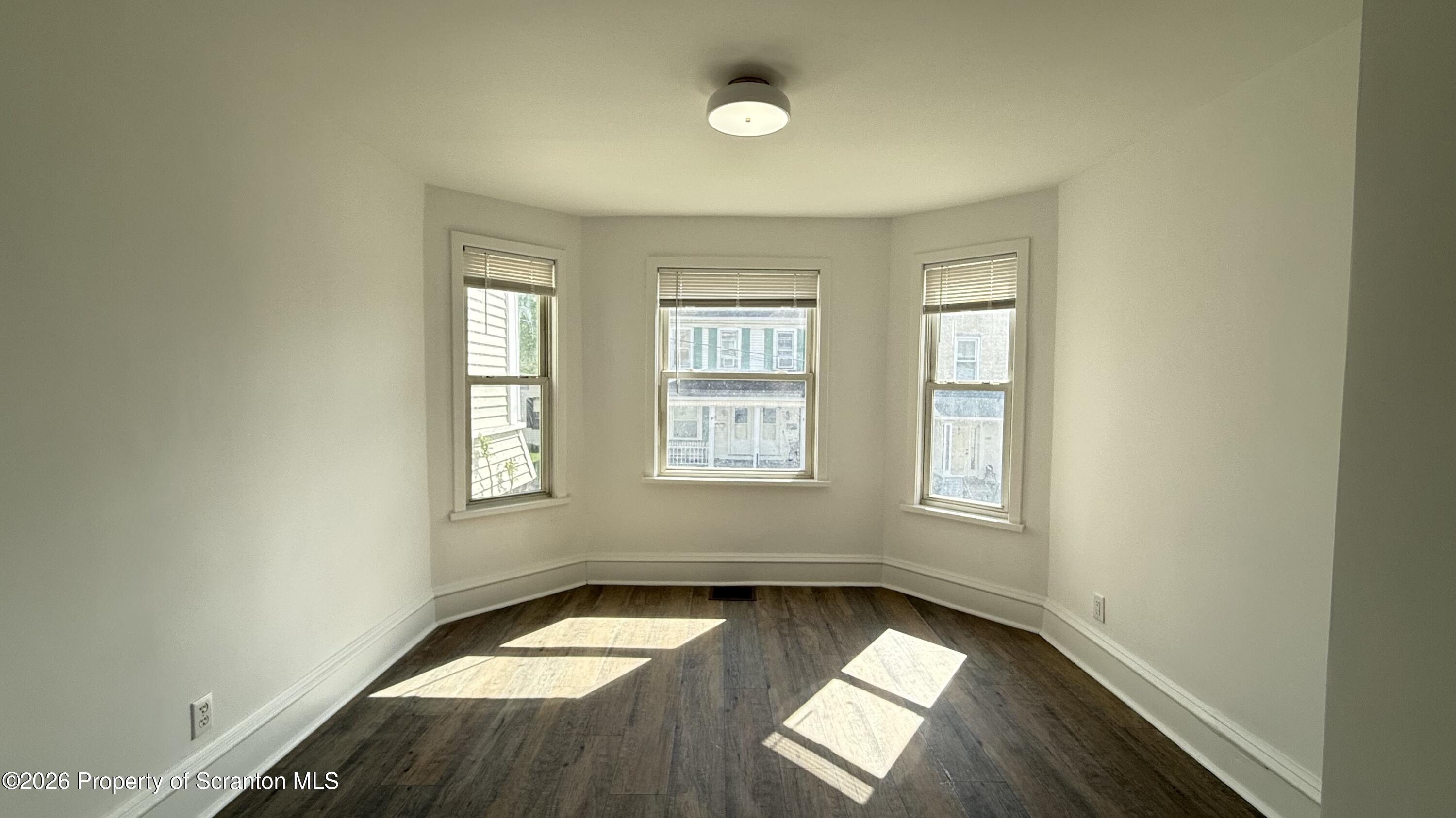 1032 Chestnut Street Sunbury, PA 17801 - Photo 13 of 25 wooden floor in an empty room with a window