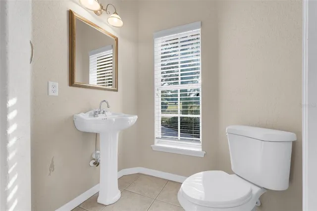 an empty room with ceiling fan and window