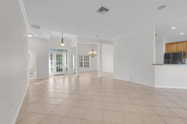 a view of kitchen with cabinets and window