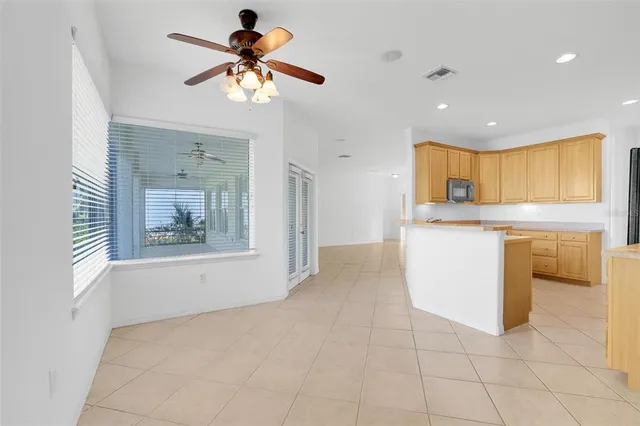 a kitchen with stainless steel appliances granite countertop a refrigerator a sink a stove and a microwave oven