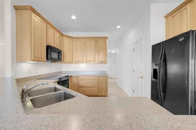 a kitchen with a sink stove and microwave
