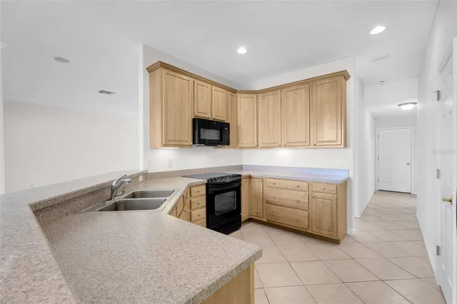 a kitchen with a sink and refrigerator