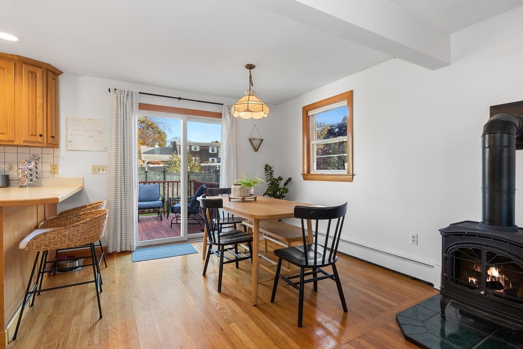 6 Auburn Road Salem, MA 01970 - Photo 14 of 32 a dining room with furniture wooden floor a rug a potted plant and a chandelier