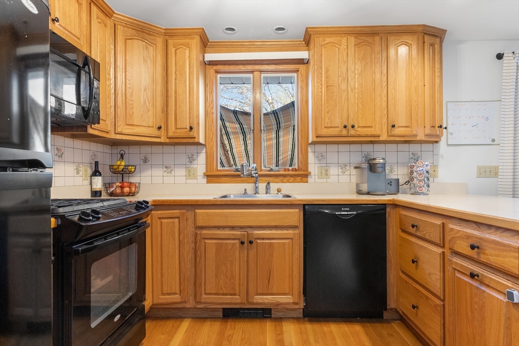 6 Auburn Road Salem, MA 01970 - Photo 9 of 32 a kitchen with stainless steel appliances granite countertop a stove a sink dishwasher and cabinets with wooden floor